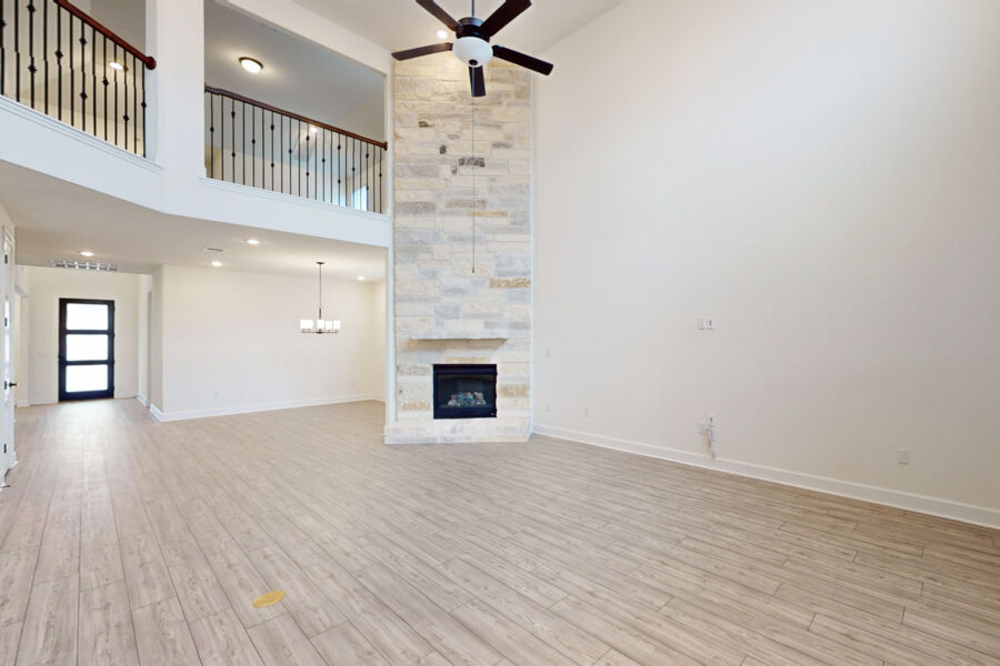3825 Waxahachie Road Leander, TX 78641 - Photo 6 of 40 a view of an empty room with wooden floor and a fireplace