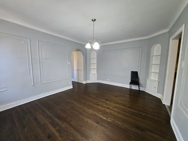 a view of a room with wooden floor staircase and a kitchen
