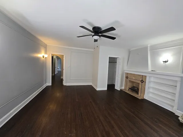 a view of an empty room with a fireplace and a window
