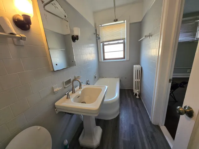 a bathroom with a sink a mirror and a toilet
