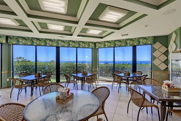a dining room with furniture water view and balcony