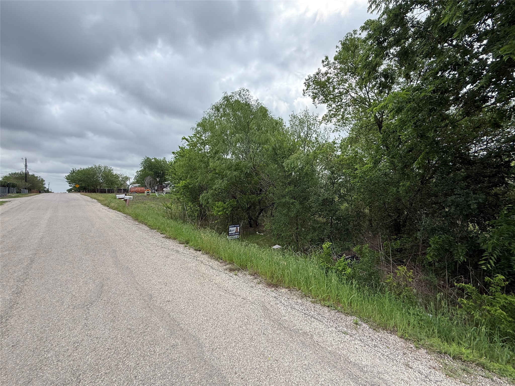 0 Dickerson Road Kyle, TX 78640 - Photo 1 of 4 The property features dense natural vegetation and a gravel road