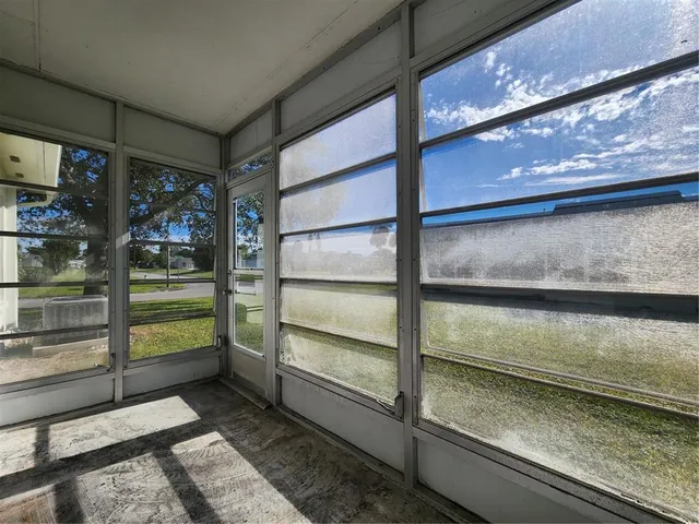 an aerial view of residential houses with outdoor space and parking
