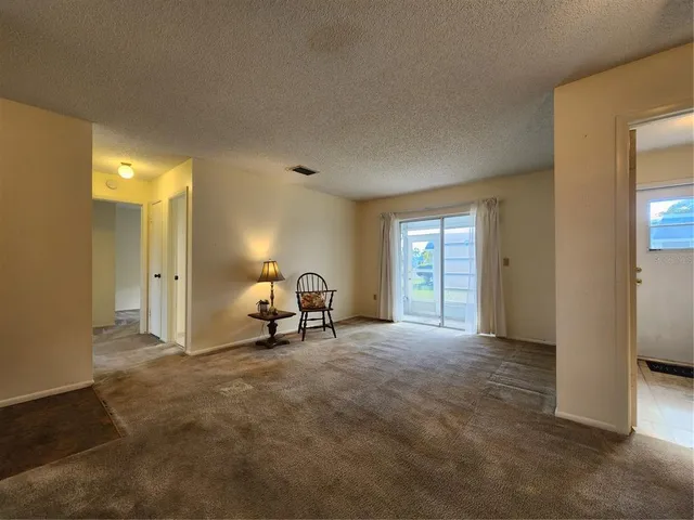 a view of a livingroom with a chair and a fireplace