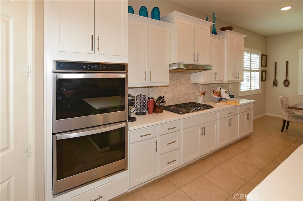 19520 Arcata Road Apple Valley, CA 92307 - Photo 14 of 53 a kitchen with white cabinets stainless steel appliances and sink