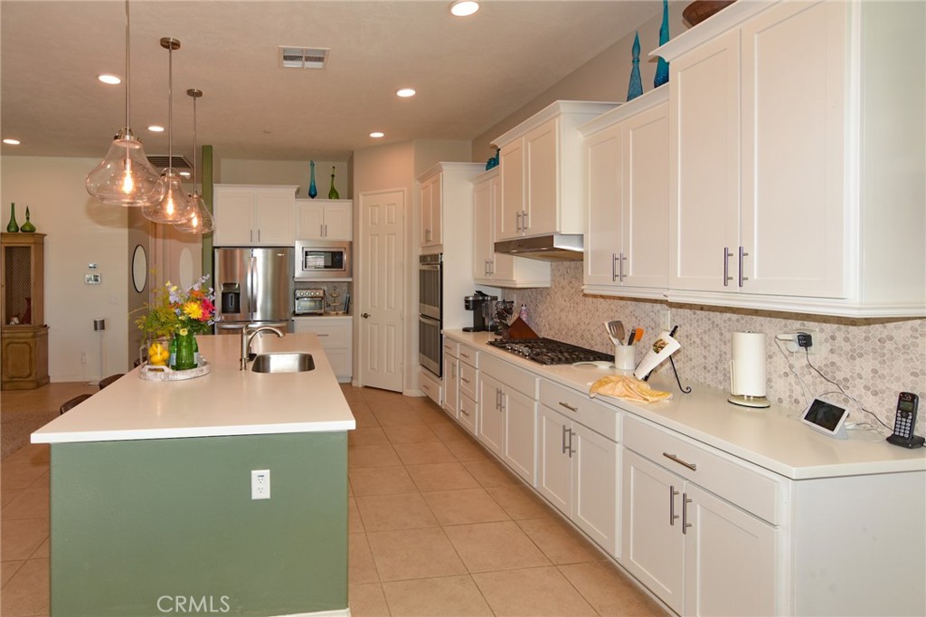 19520 Arcata Road Apple Valley, CA 92307 - Photo 15 of 53 a large white kitchen with kitchen island a sink a stove and a refrigerator