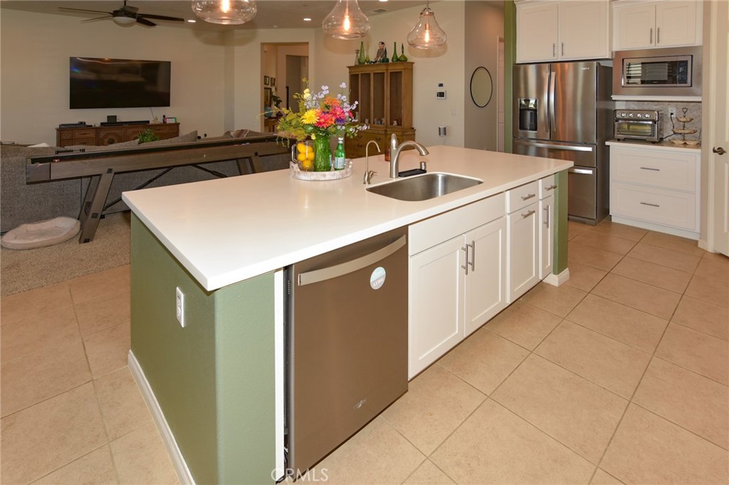19520 Arcata Road Apple Valley, CA 92307 - Photo 16 of 53 a kitchen with stainless steel appliances granite countertop a sink and a refrigerator