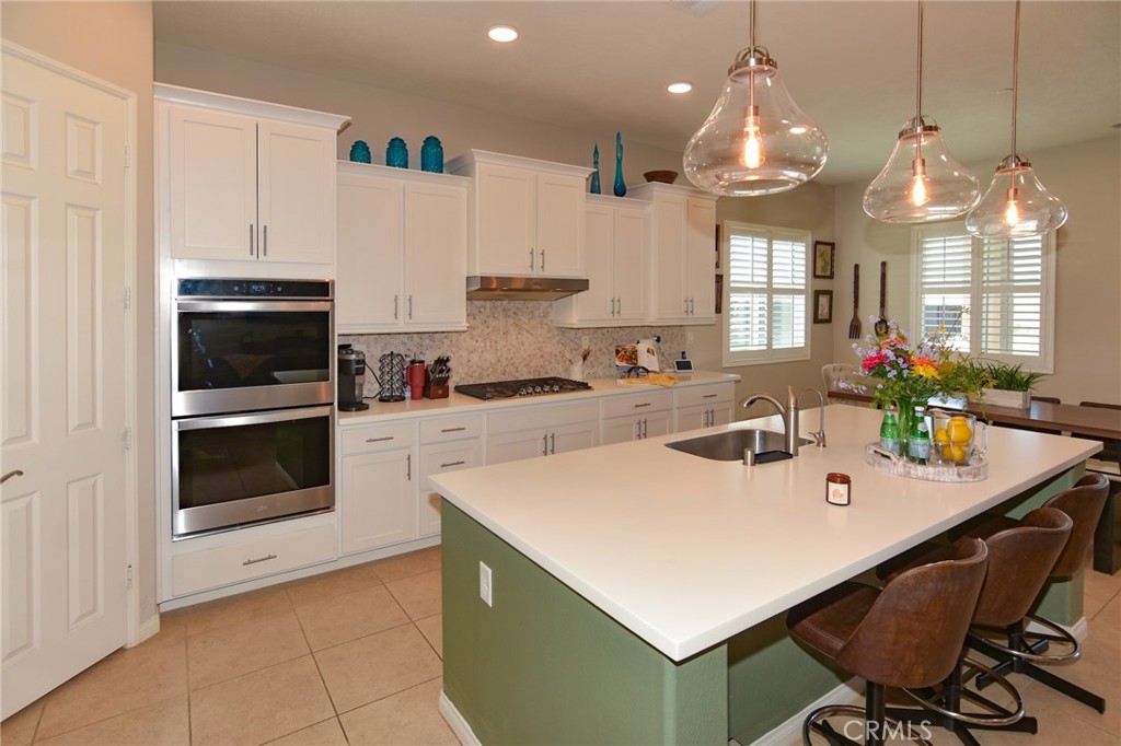 19520 Arcata Road Apple Valley, CA 92307 - Photo 17 of 53 a kitchen with a sink a stove a microwave and cabinets