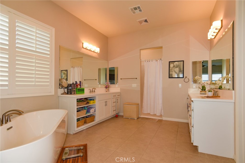 19520 Arcata Road Apple Valley, CA 92307 - Photo 24 of 53 a bathroom with a tub sink and mirror