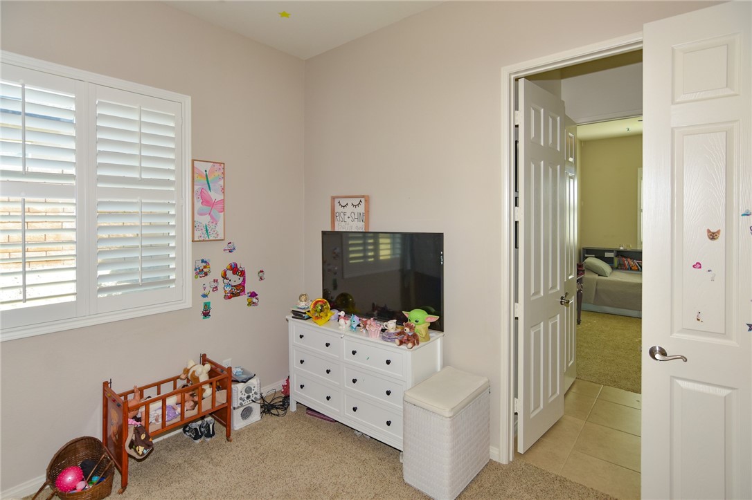 19520 Arcata Road Apple Valley, CA 92307 - Photo 30 of 53 a bedroom with furniture and a flat screen tv