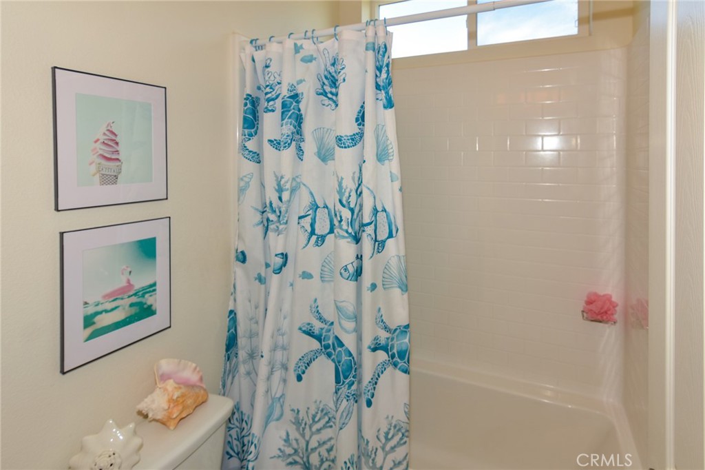 19520 Arcata Road Apple Valley, CA 92307 - Photo 32 of 53 a bathroom with a shower curtain