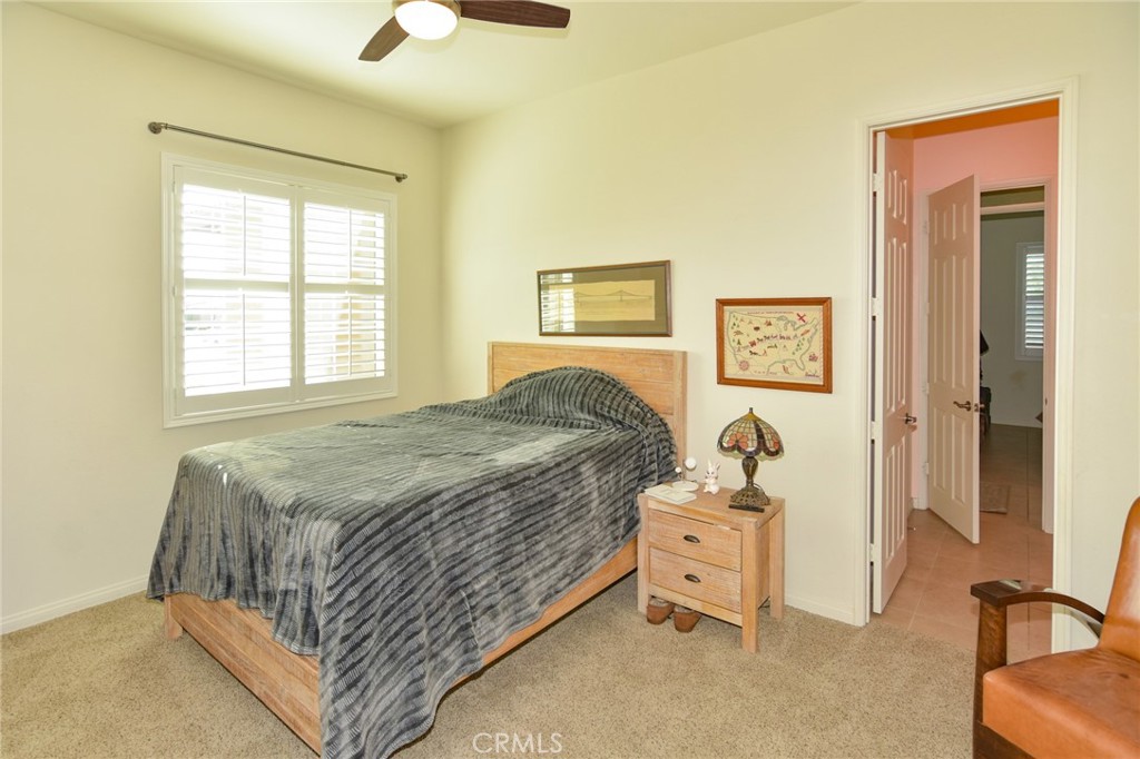 19520 Arcata Road Apple Valley, CA 92307 - Photo 33 of 53 a bedroom with a bed and a chandelier