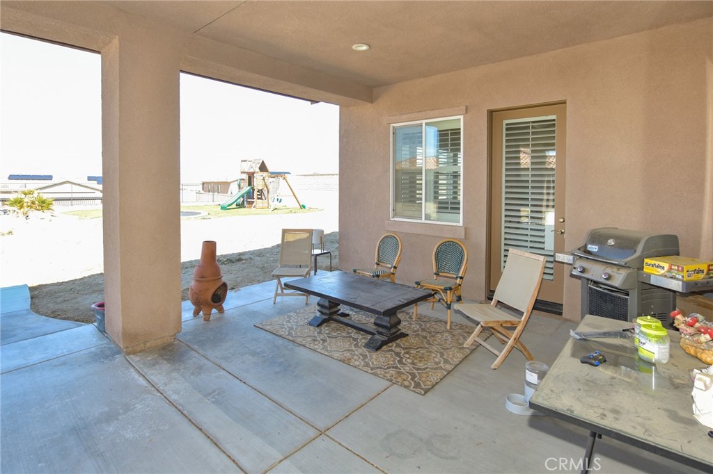 19520 Arcata Road Apple Valley, CA 92307 - Photo 44 of 53 a living room with furniture and floor to ceiling windows