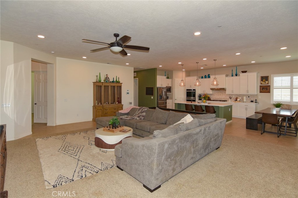 19520 Arcata Road Apple Valley, CA 92307 - Photo 10 of 53 a living room with kitchen island furniture and a dining table with kitchen view