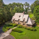 an aerial view of a house with a yard