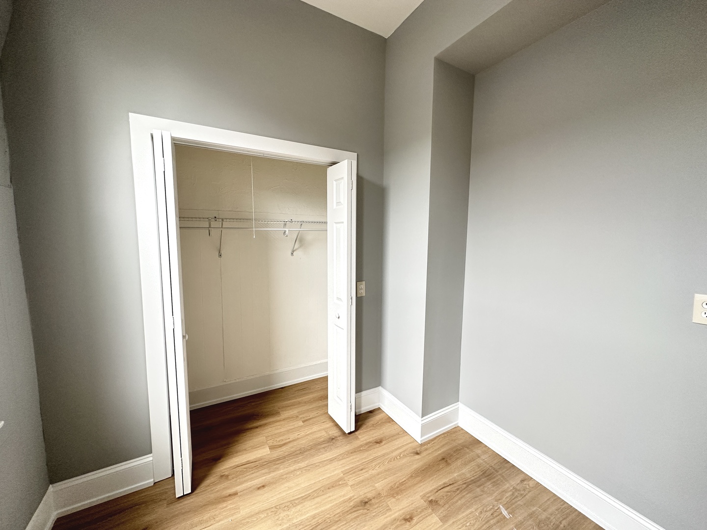 2730 West 16th Street Chicago, IL 60608 - Photo 11 of 14 a view of an empty room with wooden floor and a window