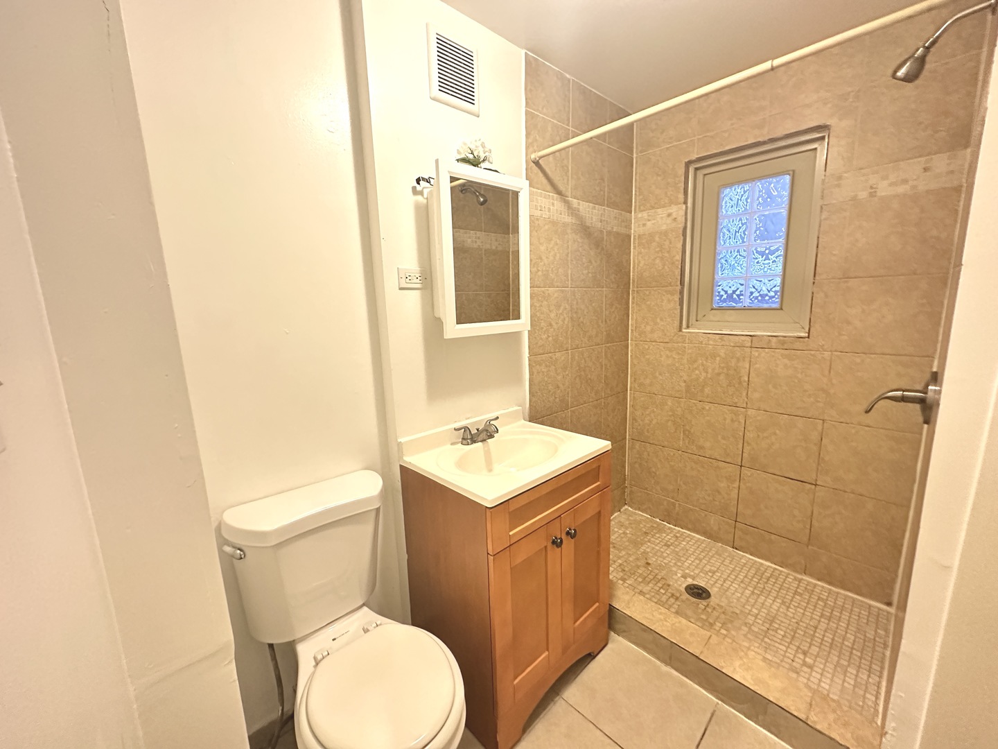 2730 West 16th Street Chicago, IL 60608 - Photo 5 of 14 a bathroom with a toilet sink vanity and shower