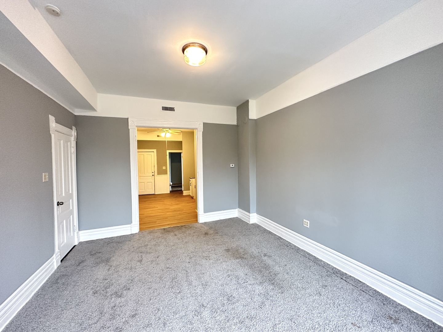 2730 West 16th Street Chicago, IL 60608 - Photo 8 of 14 a view of an empty room with wooden floor and a window