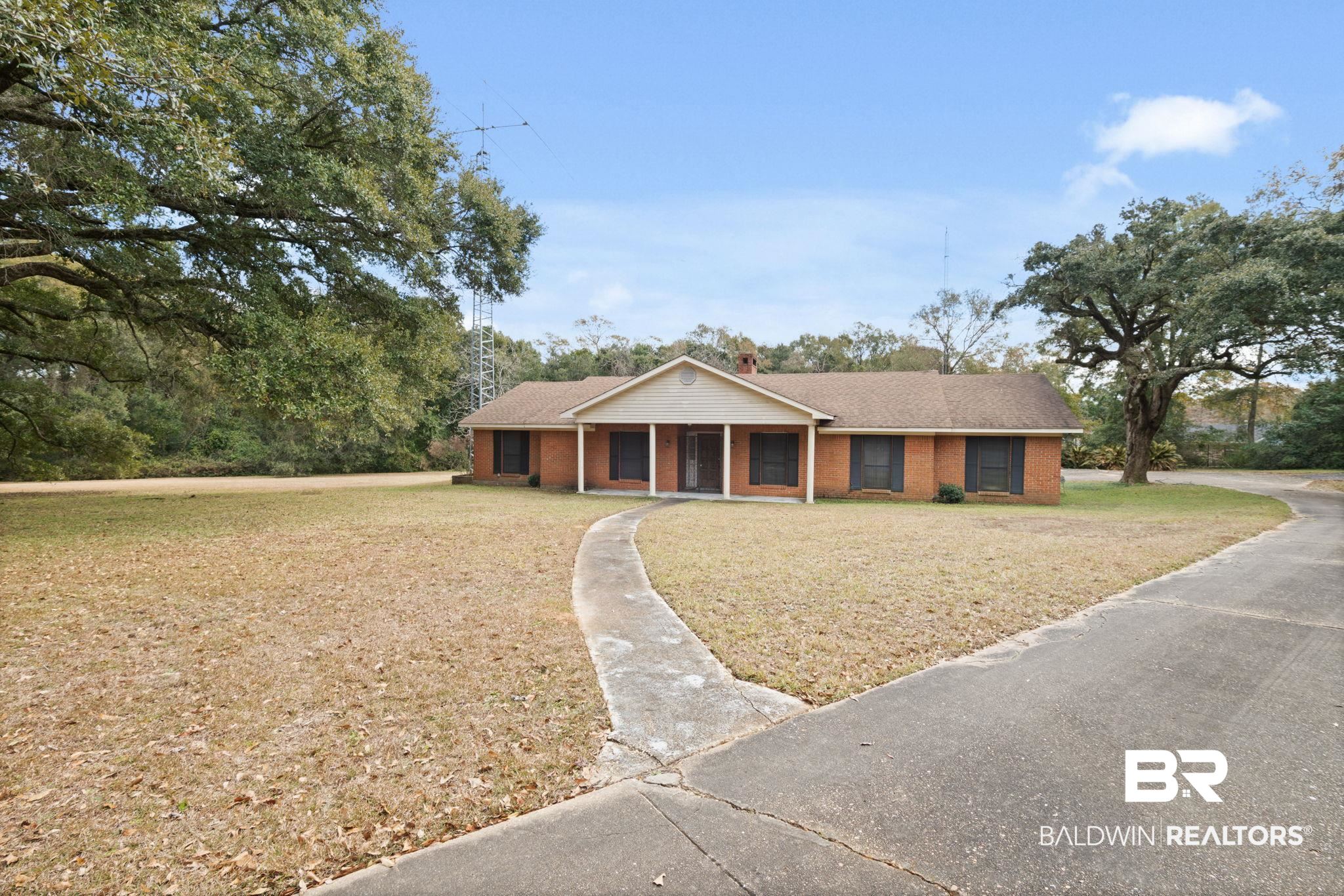 6261 Old Pascagoula Road Theodore, AL 36582 - Photo 1 of 29 Ranch-style house with a porch and a front lawn