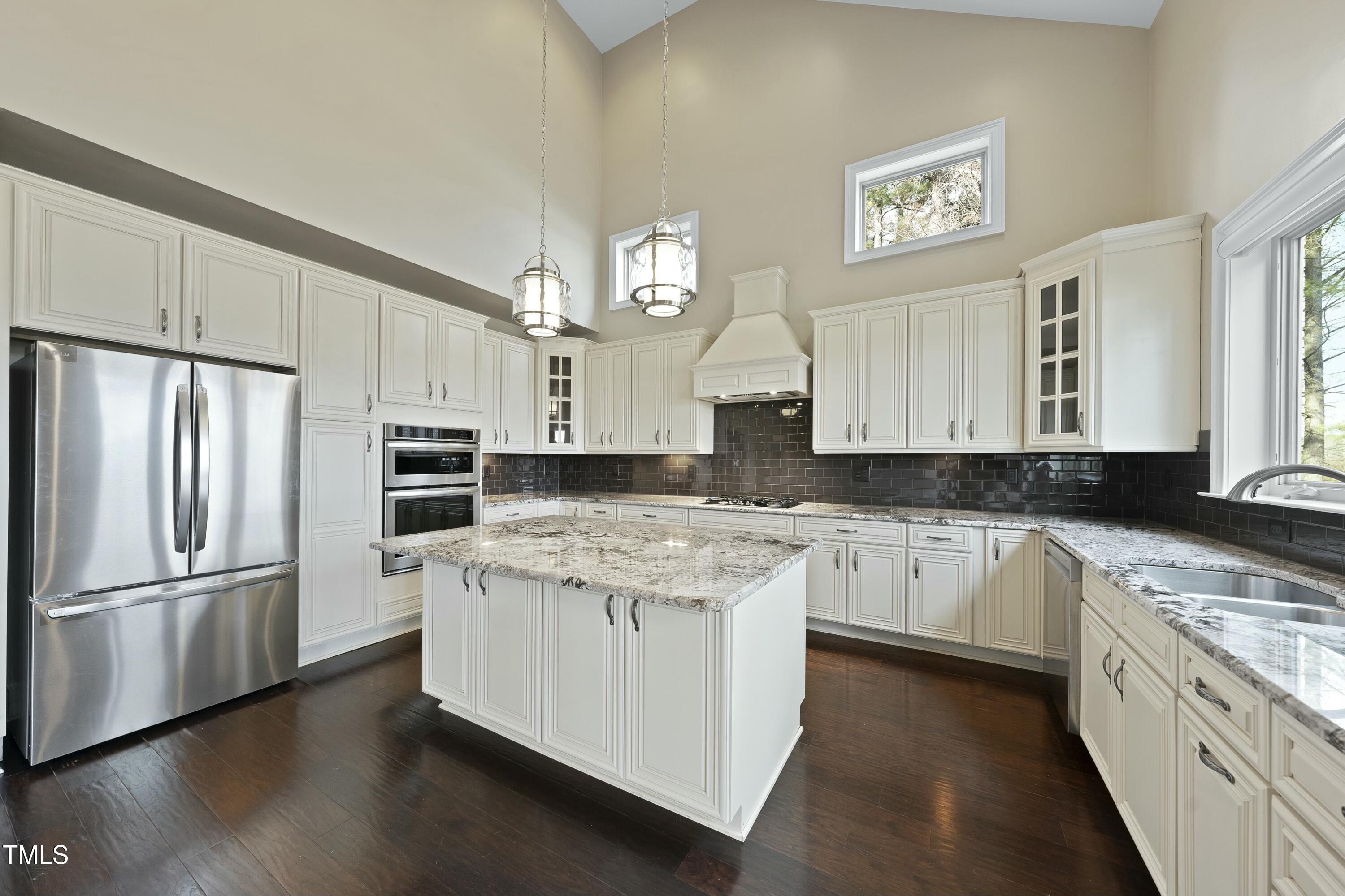 7220 Hasentree Way Wake Forest, NC 27587 - Photo 12 of 39 a kitchen with a refrigerator sink and cabinets