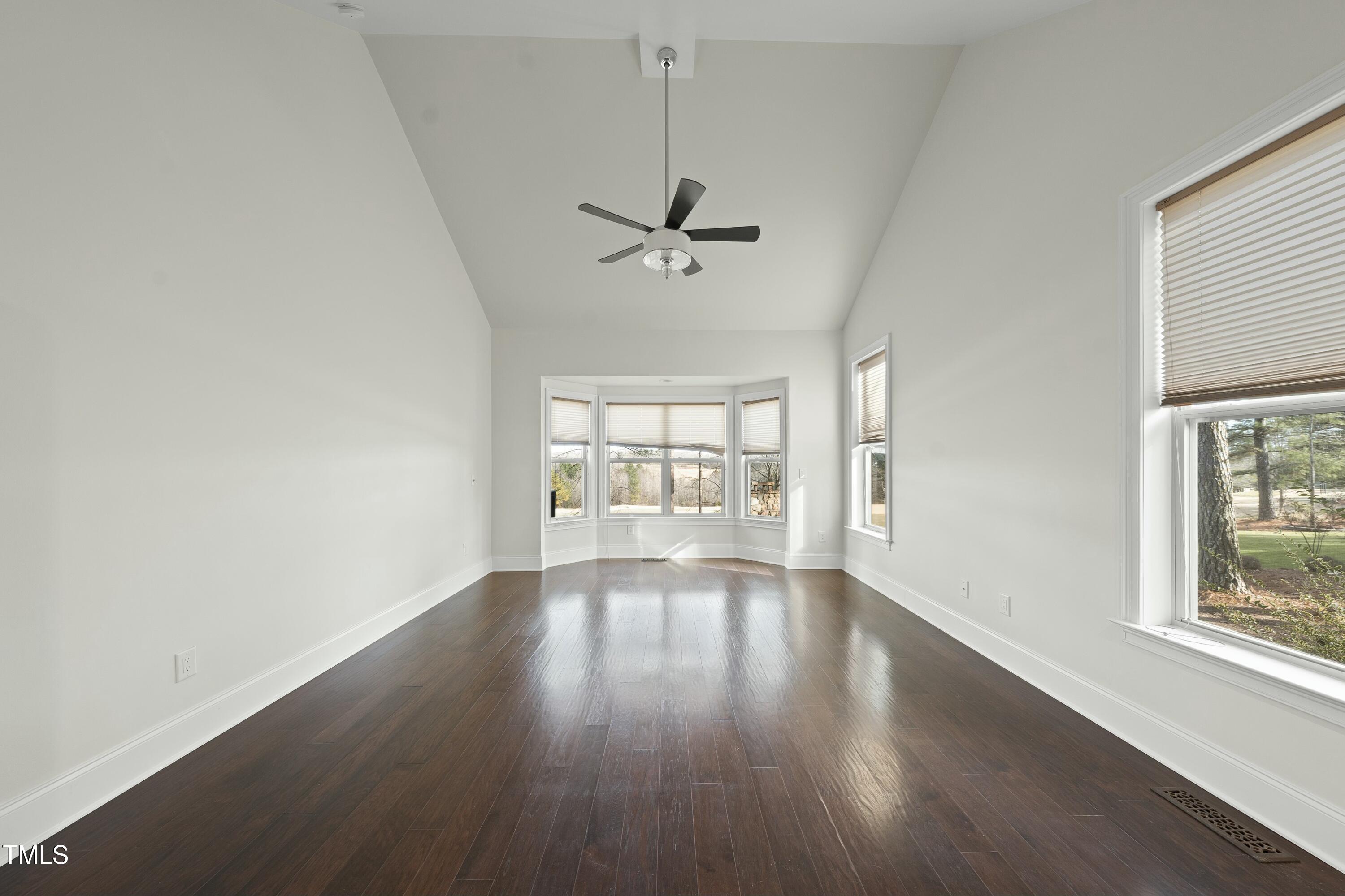 7220 Hasentree Way Wake Forest, NC 27587 - Photo 14 of 39 wooden floor in an empty room with a window
