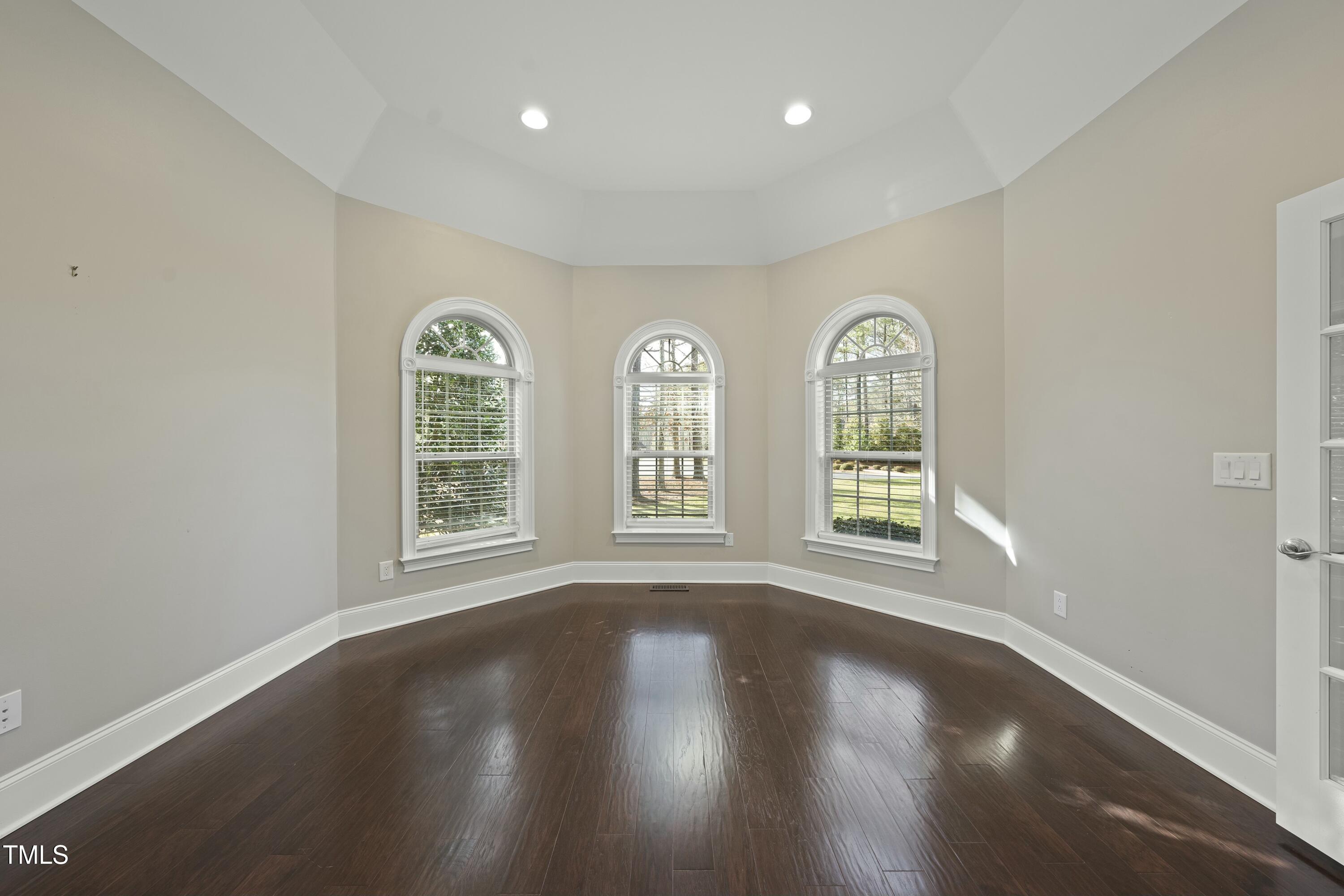 7220 Hasentree Way Wake Forest, NC 27587 - Photo 6 of 39 a view of an empty room with wooden floor and windows