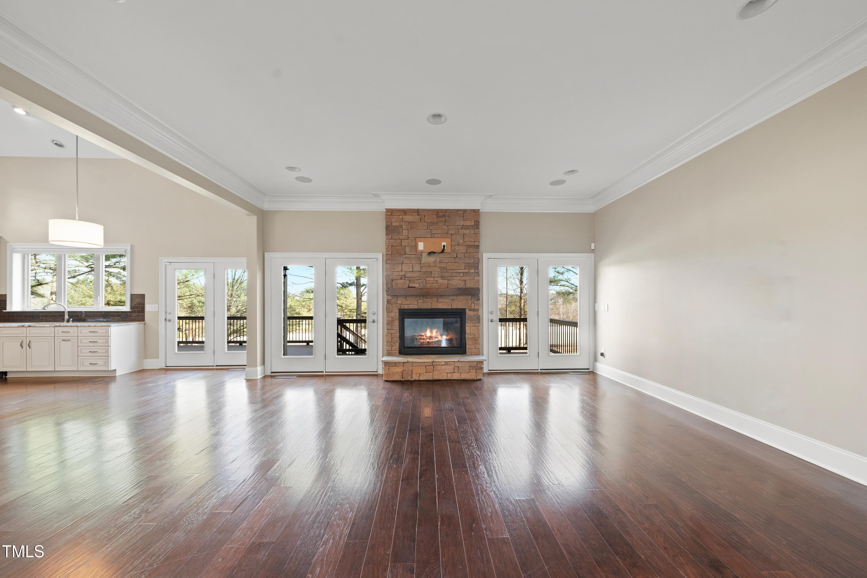 7220 Hasentree Way Wake Forest, NC 27587 - Photo 10 of 39 a view of an empty room with wooden floor fireplace and a window