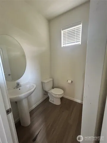 a white toilet sitting next to a small bathroom