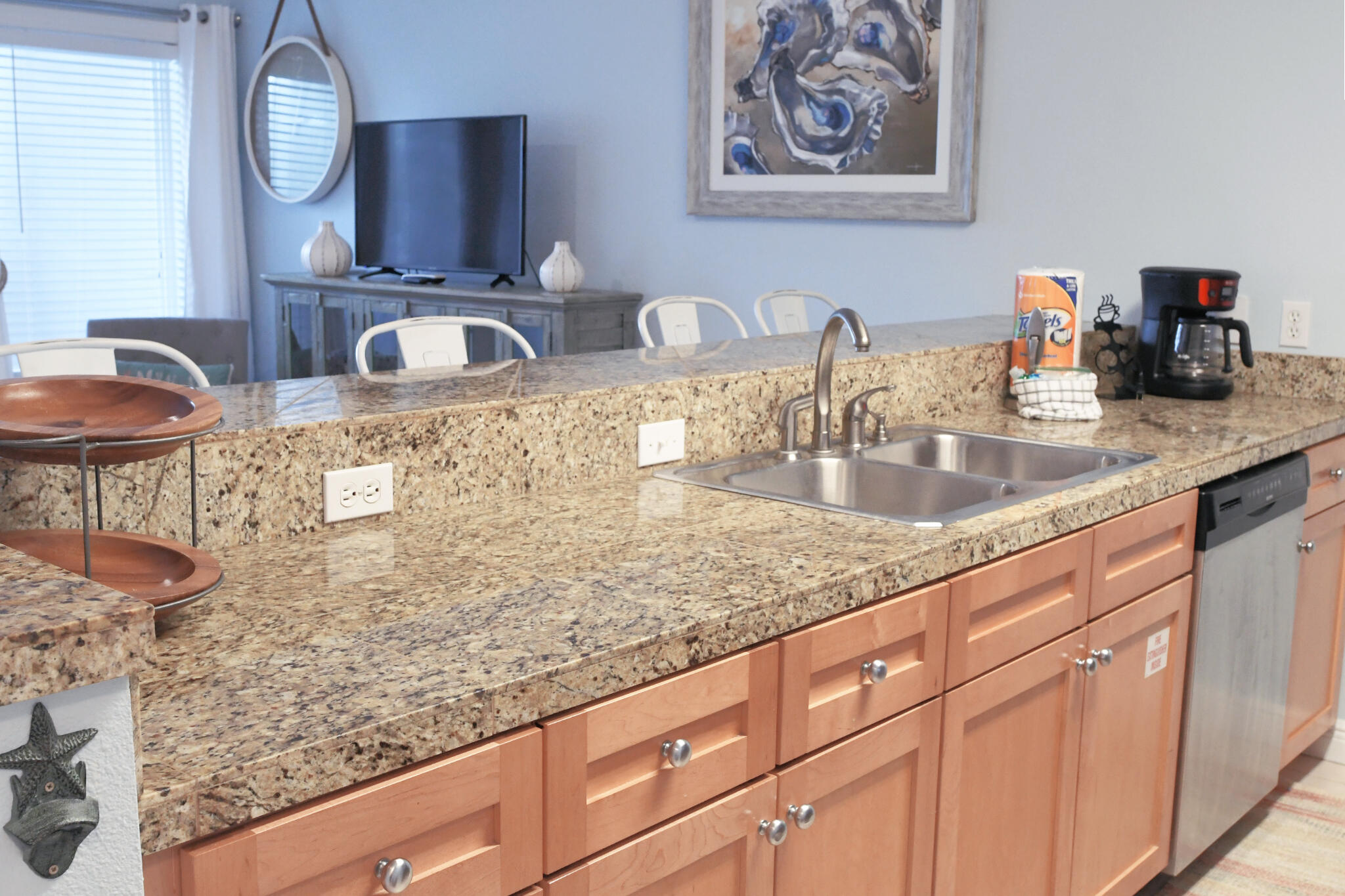 43 Cassine Way, Unit 202 Santa Rosa Beach, FL 32459 - Photo 12 of 25 a kitchen with granite countertop a sink a stove and a wooden cabinets