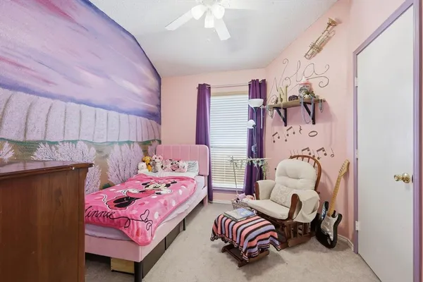 a bedroom with a bed and a chair