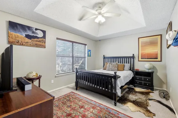 a bed room with a bed window and a chandelier