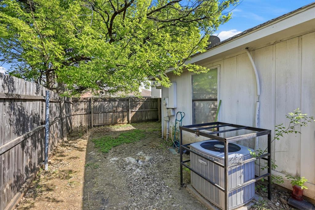 2532 Winding Road Fort Worth, TX 76133 - Photo 18 of 21 a backyard of a house with wooden fence and large trees
