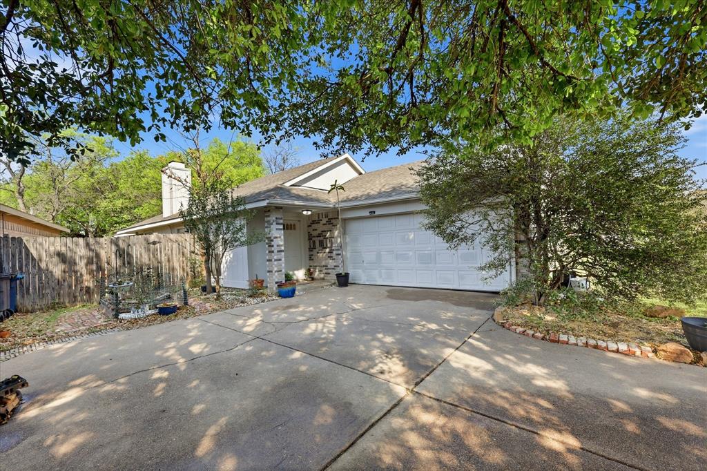 2532 Winding Road Fort Worth, TX 76133 - Photo 19 of 21 a front view of a house with a yard and garage