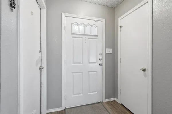 an empty room with windows and closet
