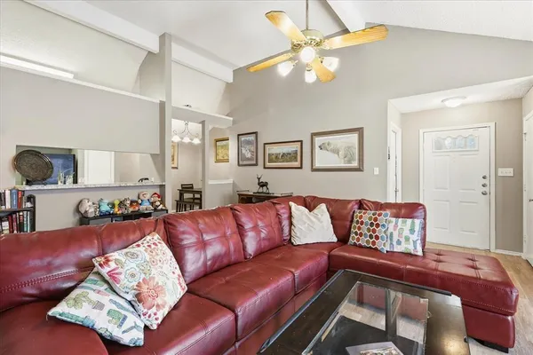 a living room with a couch and chandelier