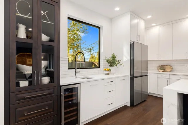 a kitchen with a refrigerator and a sink