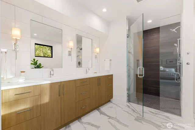 a bathroom with a double vanity sink mirror and shower