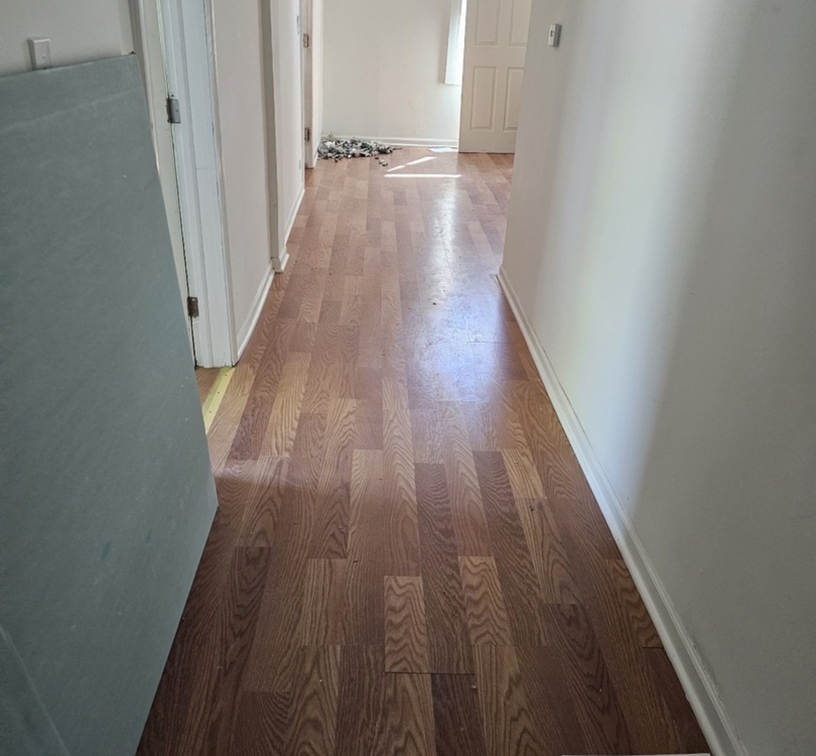 6004 South Aberdeen Street Chicago, IL 60621 - Photo 11 of 17 a view of a hallway with wooden floor