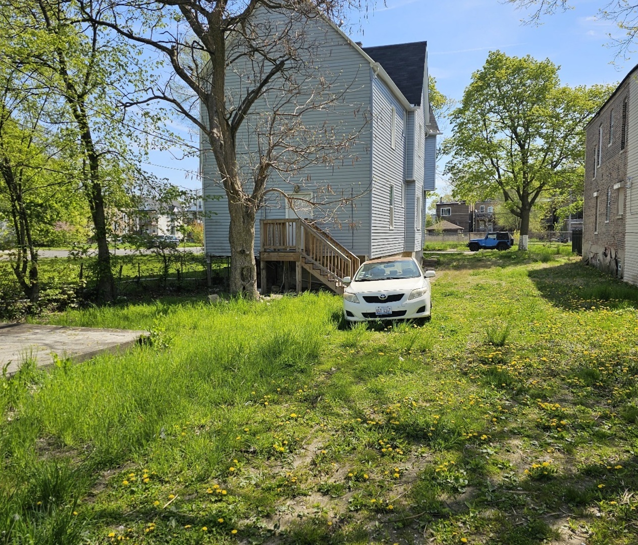 6004 South Aberdeen Street Chicago, IL 60621 - Photo 15 of 17 a backyard of a house with plants and large trees