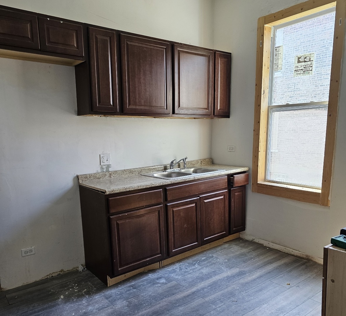 6004 South Aberdeen Street Chicago, IL 60621 - Photo 3 of 17 a kitchen with stainless steel appliances granite countertop wooden cabinets a refrigerator a sink and dishwasher with wooden floor