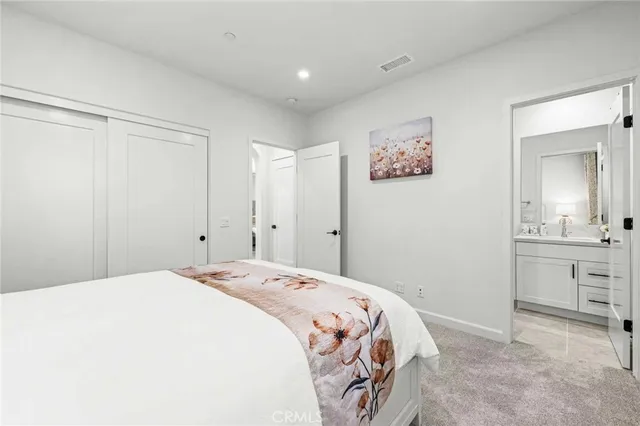 a bedroom with a bed and a mirror