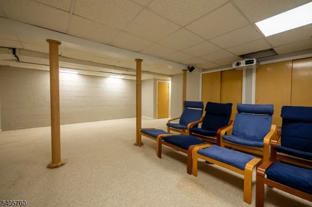 a living room with furniture and a pool table