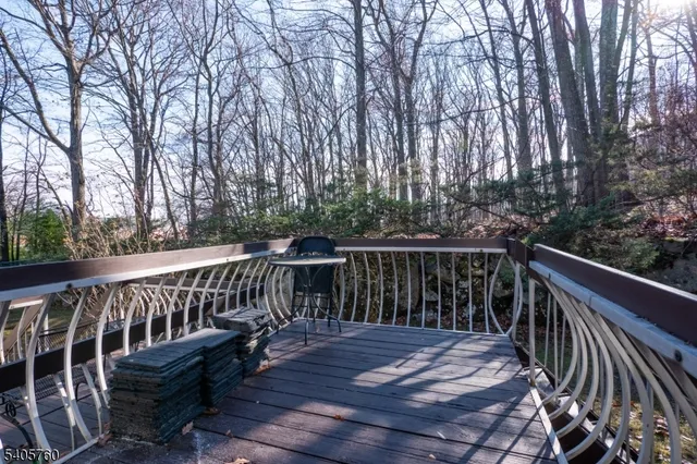 a view of balcony with furniture and trees