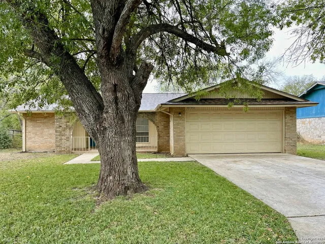 a front view of a house with a garden and yard