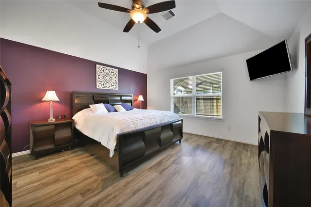 a bedroom with a bed and a chandelier