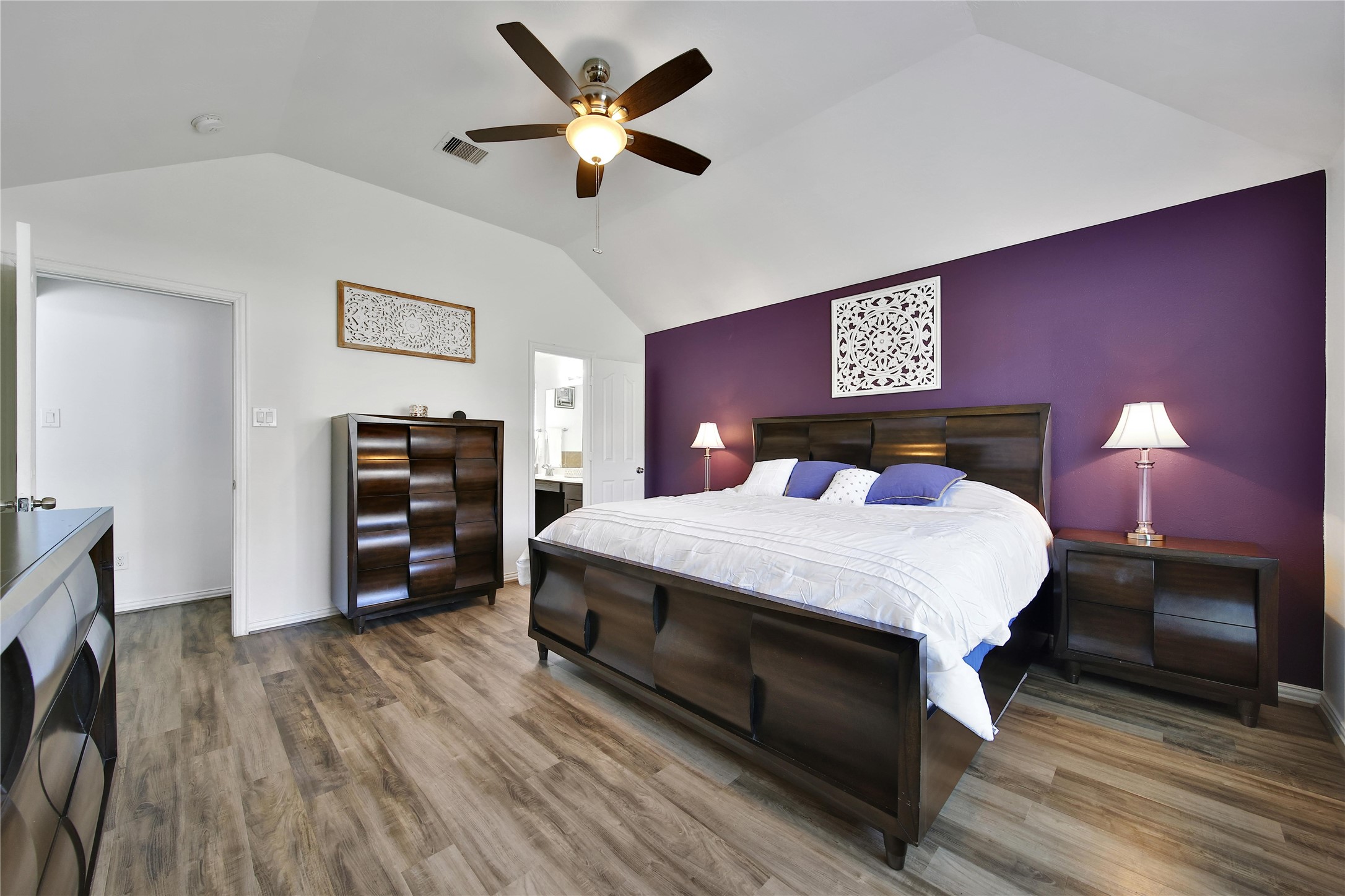 23411 Sawmill Pass Spring, TX 77373 - Photo 13 of 20 a bedroom with a bed and a chandelier
