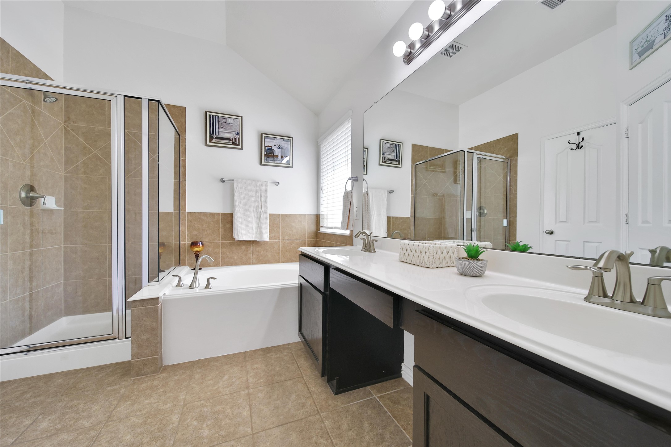 23411 Sawmill Pass Spring, TX 77373 - Photo 14 of 20 a spacious bathroom with a sink double vanity mirror and a bathtub