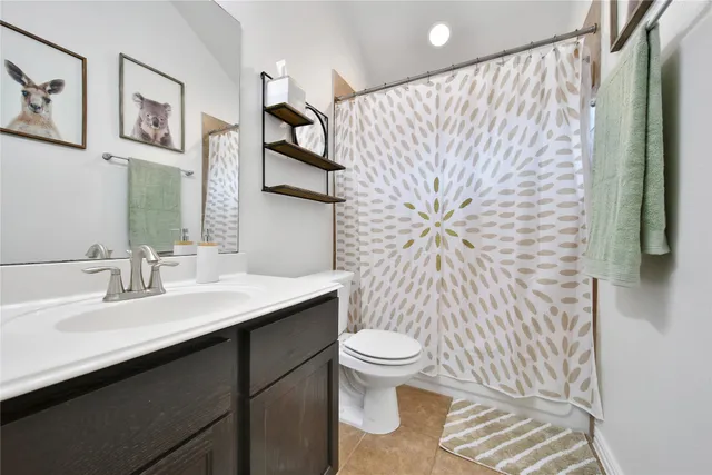 a bed sitting in a bedroom next to a window and a chandelier