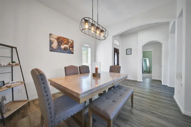 a kitchen with stainless steel appliances granite countertop a refrigerator a stove and a sink