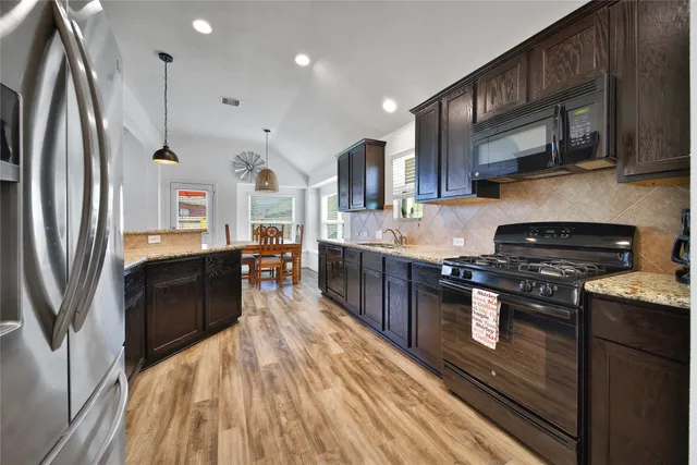 a kitchen with a sink stove and refrigerator